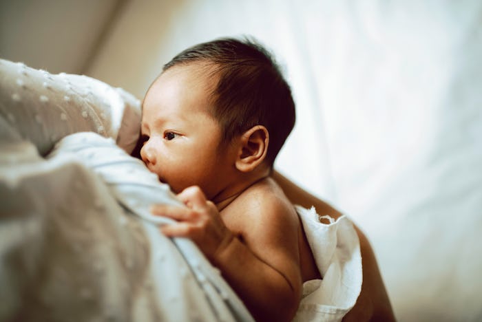 Woman Breastfeeding A Newborn Baby