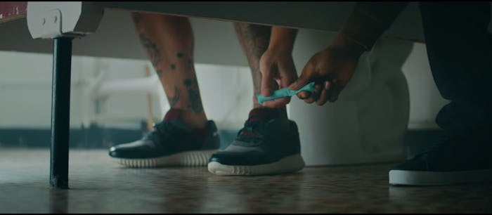 Man passes tampon under bathroom stall in new Thinx ad.