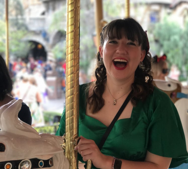 A woman smiling on the carousel at Disney, which is a perfect Disneyland activity for couples to do....