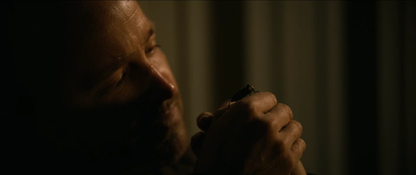 Aaron Paul as Jesse Pinkman looking at beetle in 'El Camino: A Breaking Bad Movie'
