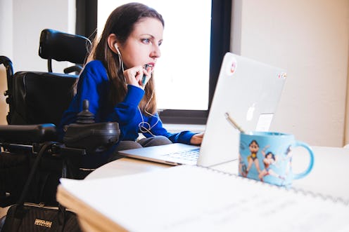 A woman looks over financial records at her desk. Saving For Retirement When You're In Your 20s does...