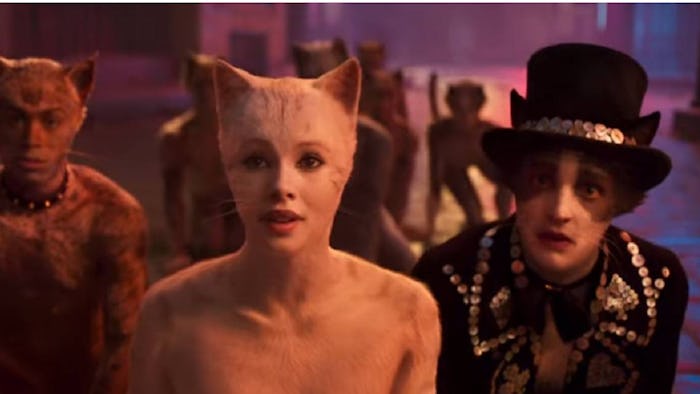 three cat characters stand side by side in still from Cats the movie