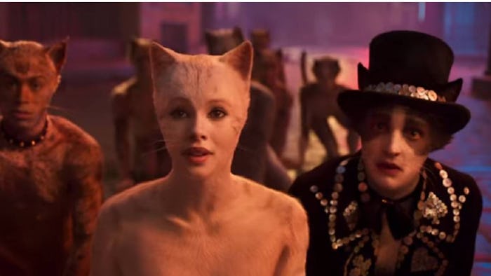 three cat characters stand side by side in still from Cats the movie