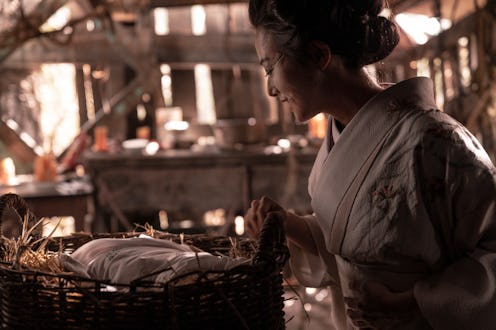 Kiki Sukezane as Yuko standing over a baby in a basket in The Terror: Infamy