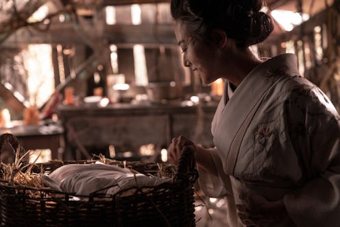 Kiki Sukezane as Yuko standing over a baby in a basket in The Terror: Infamy