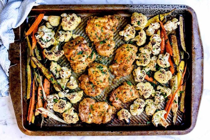 tandoori chicken with vegetables on a sheet pan