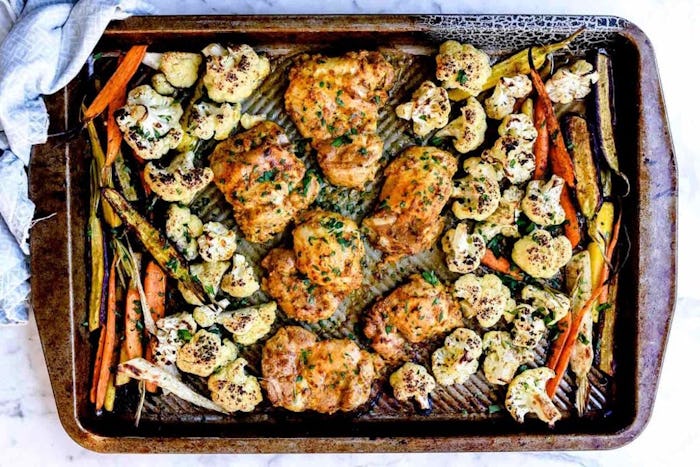 tandoori chicken with vegetables on a sheet pan