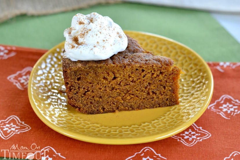 slow cooker pumpkin pie cake with whipped cream sitting on yellow plate