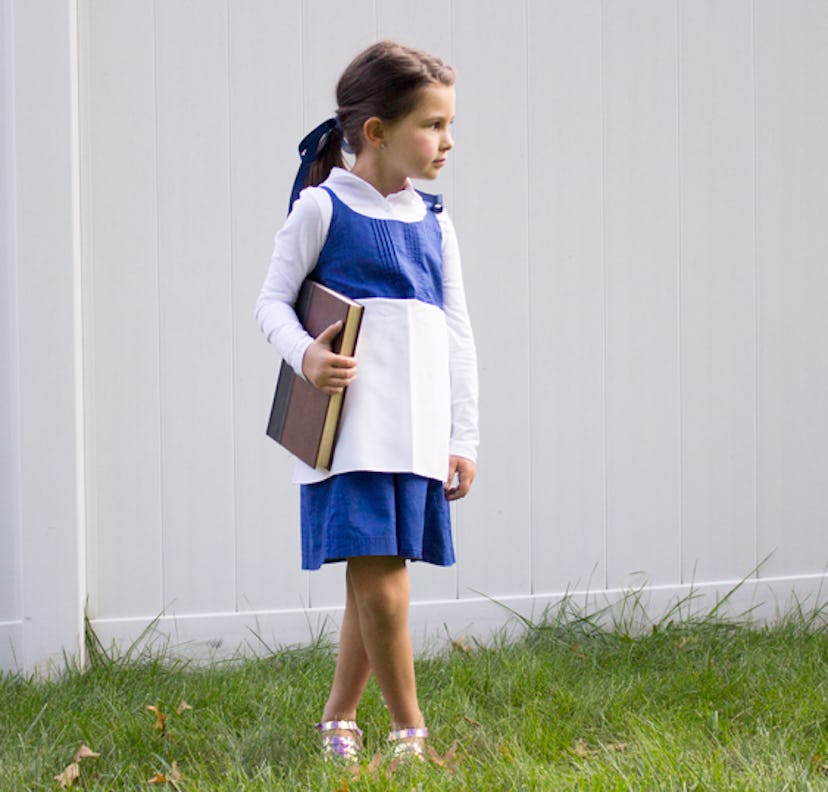 Small child in Halloween costume of Belle from Beauty and The Beast