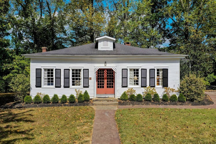 The historic home on the Jim Beam American Stillhouse distillery grounds has a bright red door and b...