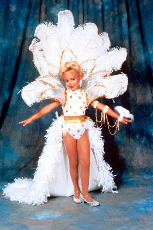 JonBenet Ramsey in a beauty pageant in a white feathered outfit