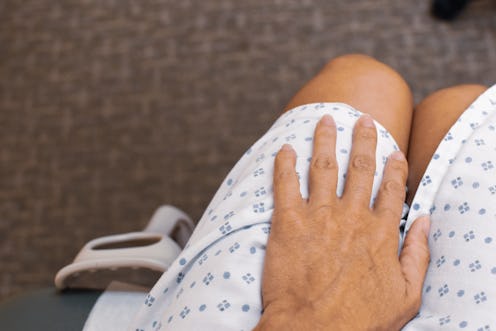 A patient in a medical gown awaits the results of an STI test