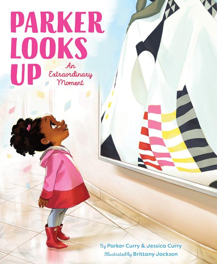 A little girl looks up at a portrait of Michelle Obama on the cover of "Parker Looks Up"