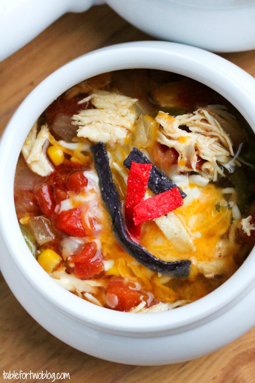 close up of slow cooker chicken tortilla soup in white bowl