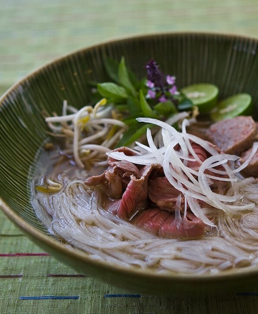 close up sideview of a bowl of slow cooker pho in a bowl