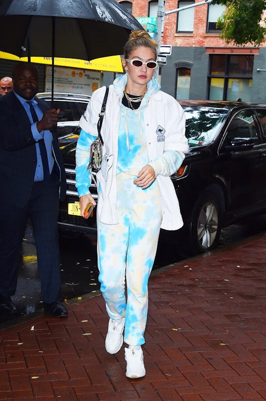 Gigi Hadid wears a tie dye sweatsuit by Wsly Vintage.