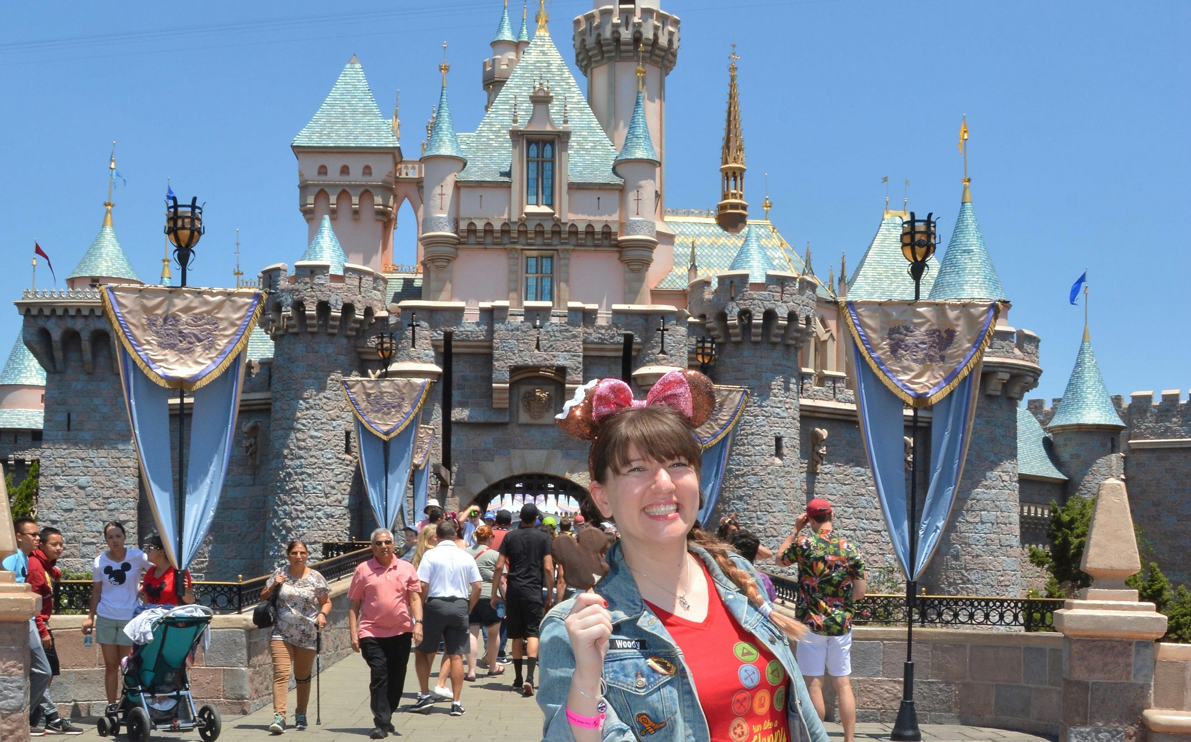 A woman holding a Mickey ice cream in front of the castle would need Mickey-shaped food captions for...