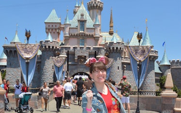 A woman holding a Mickey ice cream in front of the castle would need Mickey-shaped food captions for...