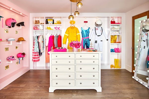 The walk-in closet of Airbnb's Barbie Malibu Dreamhouse has outfits from all of Barbie's many career...