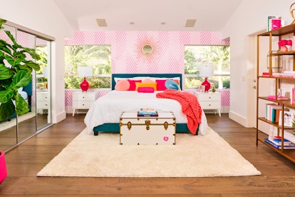 The master bedroom in Barbie's Malibu Dreamhouse is decorate with brightly-colored pillows, a fuzzy ...