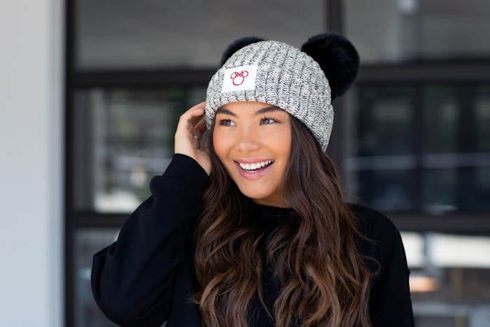 Young woman wearing a hat from the Disney and Love Your Melon Collaboration 