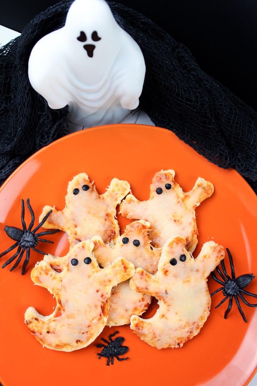 Halloween mini pizzas are even more fun when you cut them into spooky shapes.