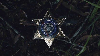 Chief Judd Crawford's badge with blood splattered on it from Watchmen