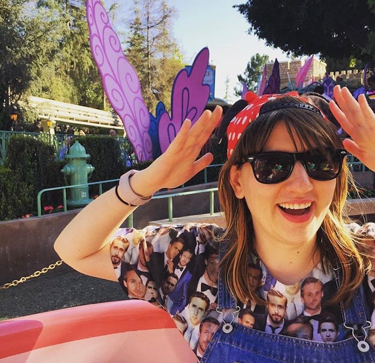 A woman wearing a Minnie Mouse hat while sitting in the teacups at Disneyland. 
