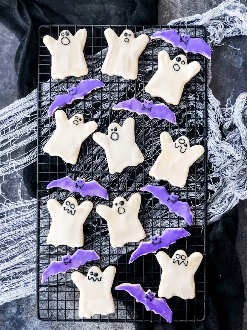 Decorated sugar cookies in the shape of ghosts and bats are perfectly imperfect Halloween snacks for...