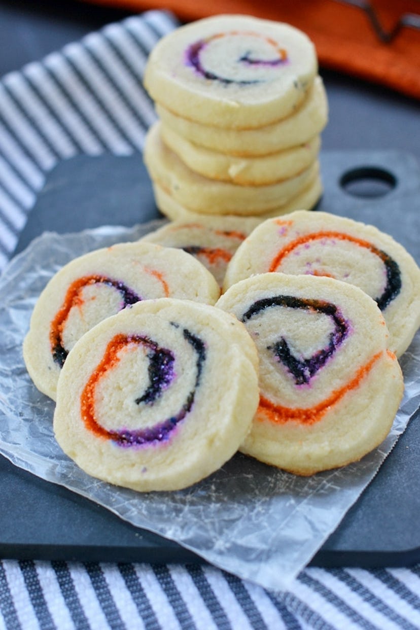 Halloween spiral slice and bake cookies feature purple and orange sprinkles inside, perfect for a Ha...