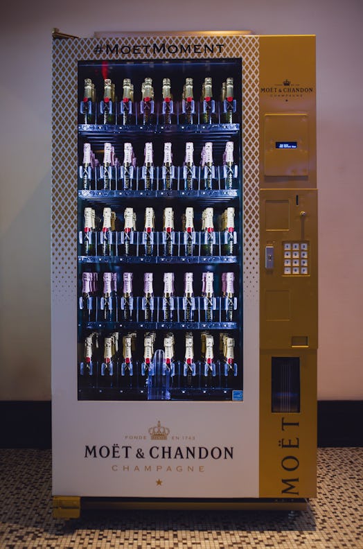 The Moët & Chandon vending machine In NYC has two kinds of champagne in it and a gold and white exte...