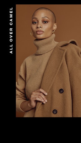A woman wearing a camel turtleneck with a matching wool coat