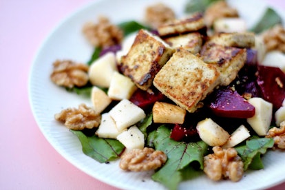 A salad with walnuts, apples, and beets. Eliminating meat from your diet can alter your genetic mate...