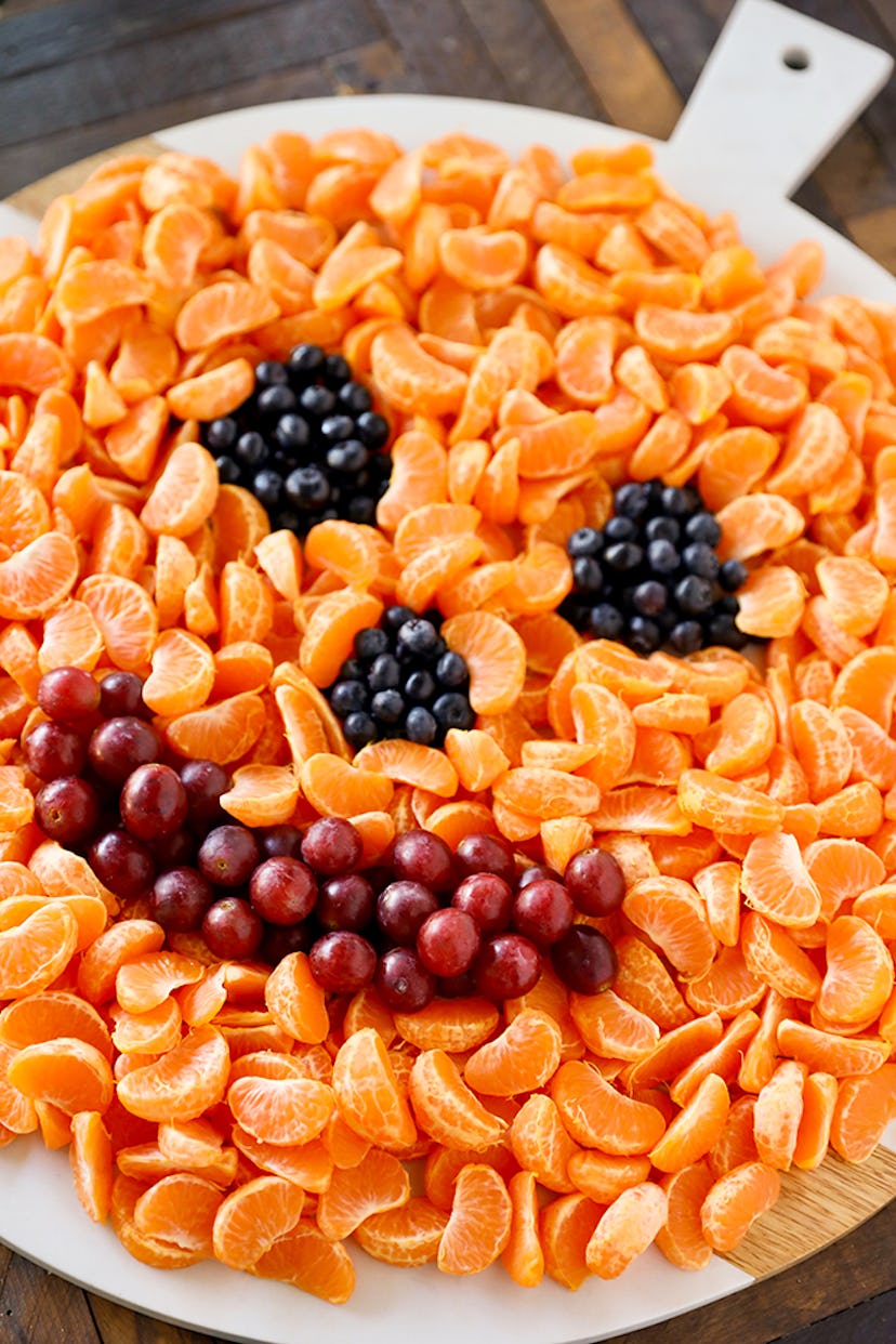 A Jack O' Lantern Fruit Tray makes a healthy and delicious Halloween snack for the classroom. 