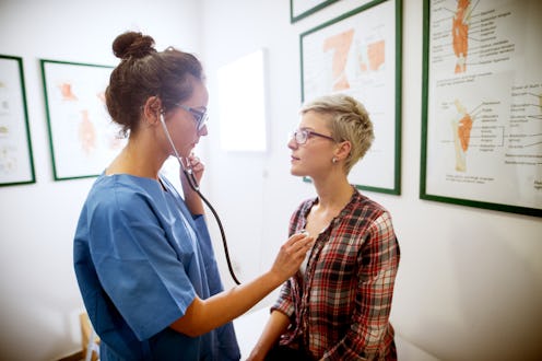 A woman having her heartbeat checked by a nurse at the doctor's office. Social smoking can create se...