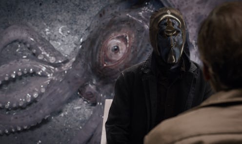 An image of a squid behind Tim Blake Nelson as "Looking Glass" in Watchmen