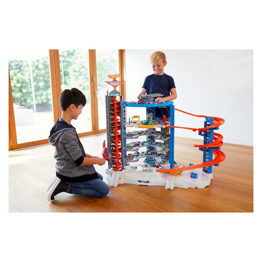 Two boys playing with Hot Wheels Ultimate Garage Playset from Target