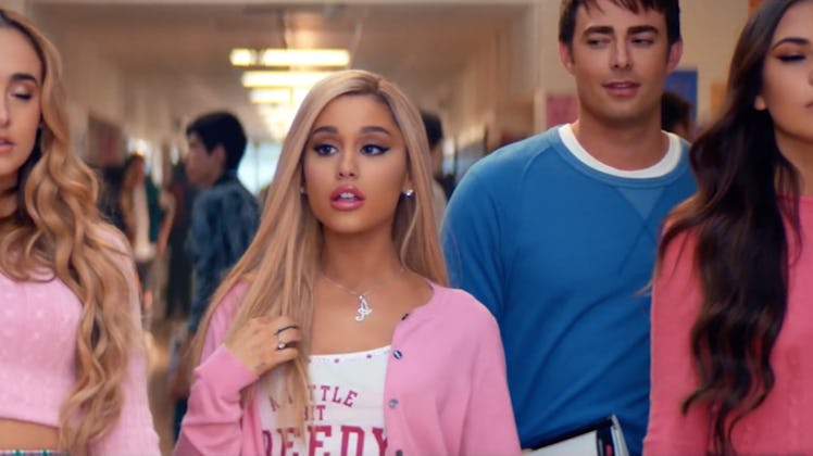 Ariana Grande dresses as Regina George from 'Mean Girls' with a pink cardigan and white tank top on....