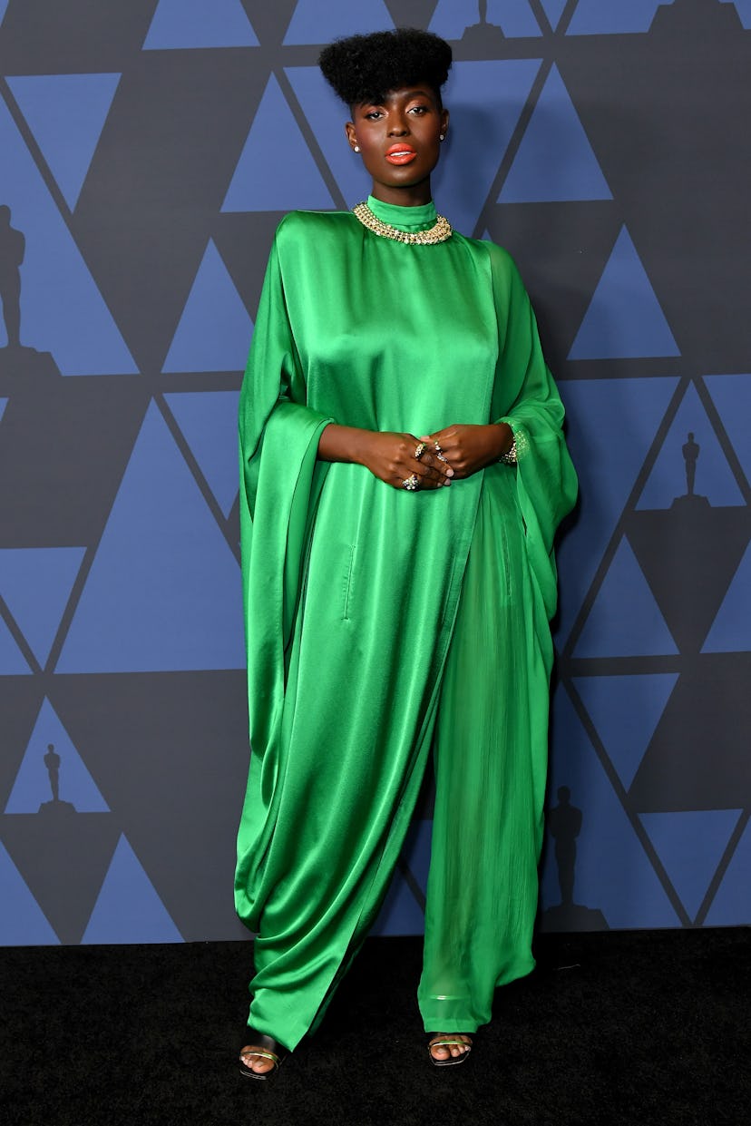 Jodie Turner-Smith posing in a green, draped jumpsuit at the 2019 Governors Awards