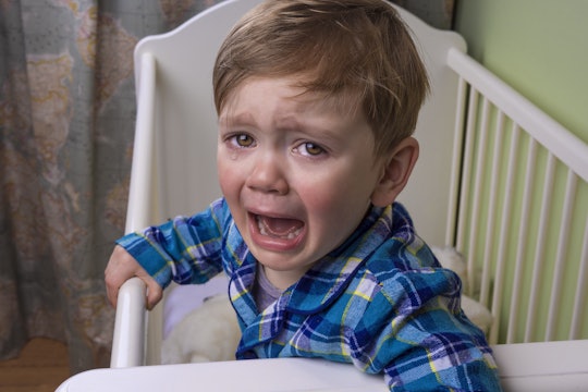 Toddler-aged child crying in crib.