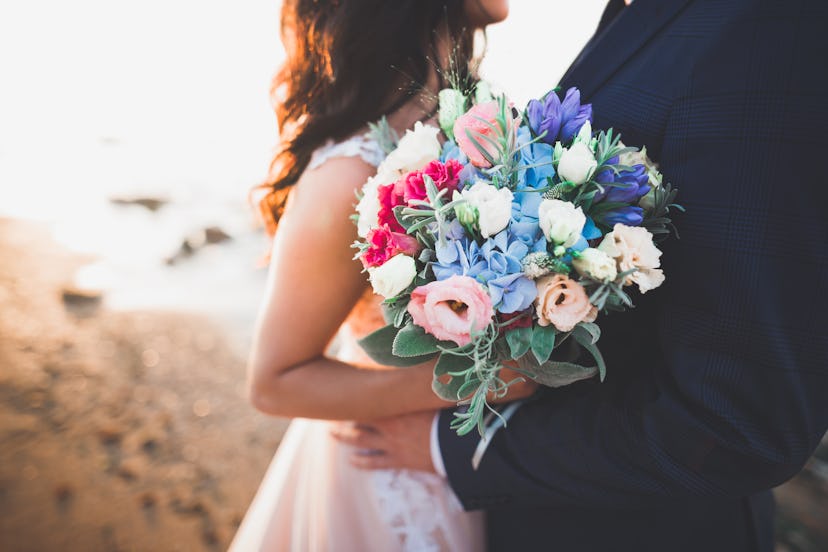 Bride carrying colorful wedding bouquet