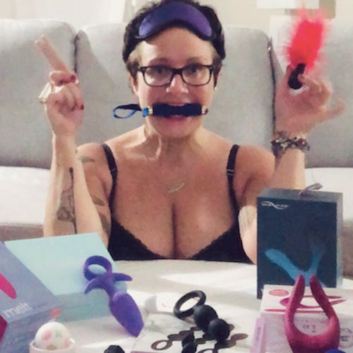 Woman poses with a variety of favorite sex toys. 