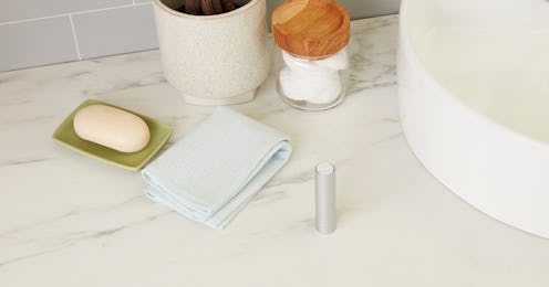 quip's new Refillable Floss on bathroom counter beside sink