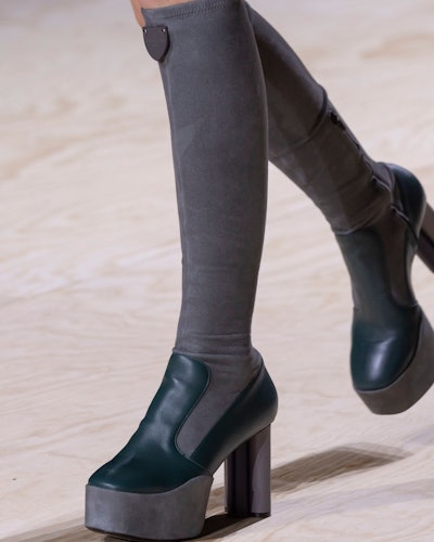A model wearing grey-black platform ankle boots  as on of the 7 Spring/Summer runway shoe trends