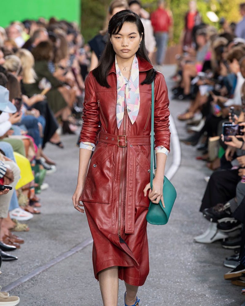 A model wearing a burgundy dress and heels as on of the 7 Spring/Summer runway shoe trends