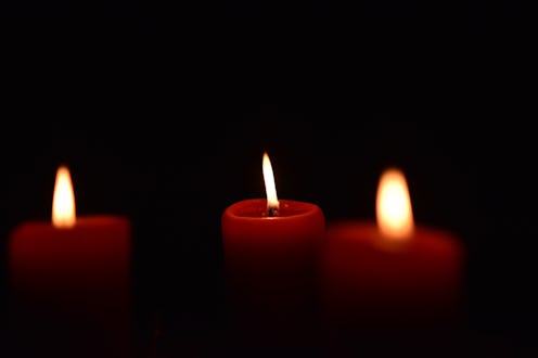 Red candles burn against a black backdrop in this story about witchcraft, books, and witches of colo...