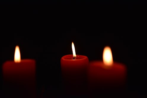 Red candles burn against a black backdrop in this story about witchcraft, books, and witches of colo...