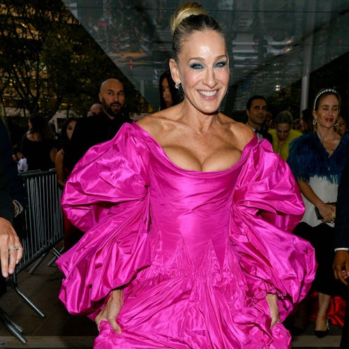 Sarah Jessica Parker in a puffy purple dress with her hair in a bun at a red carpet event