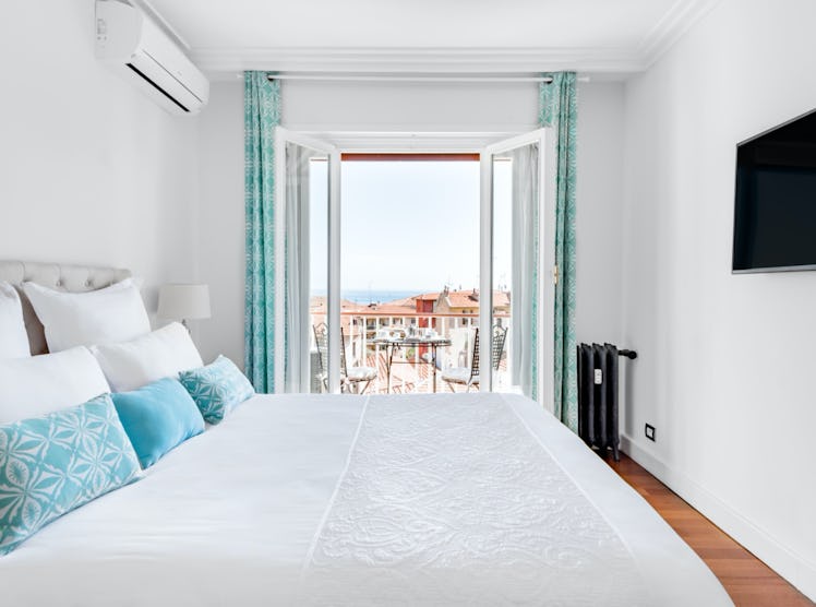 The bedroom of an apartment in Beaulieu-sur-Mer is very bright and has a gorgeous view of the ocean ...