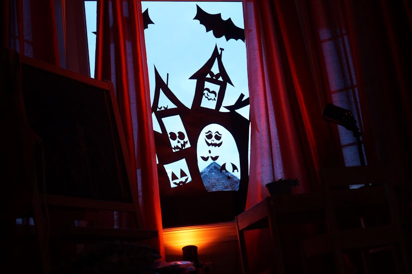 Window decorations in the shape of a haunted house